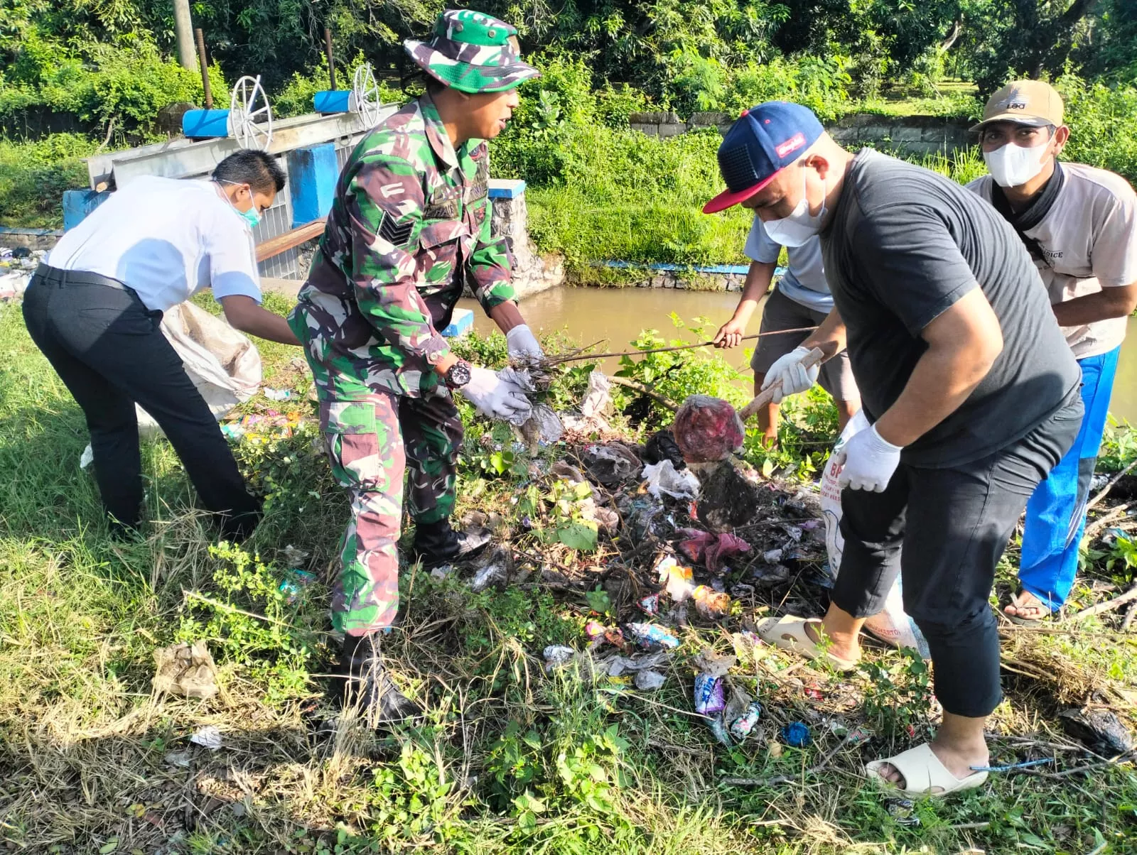 Babinsa Koramil Ploso Gelar Karya Bakti di Bantaran Sungai Desa Daditunggal